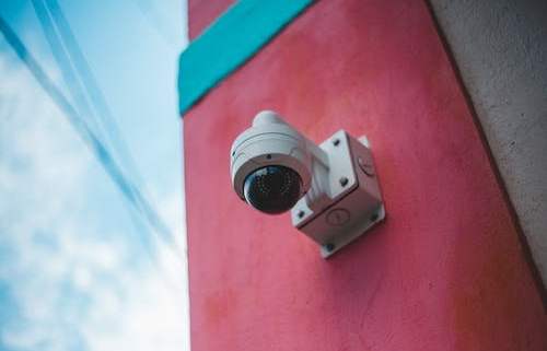 A security camera mounted on an exterior wall