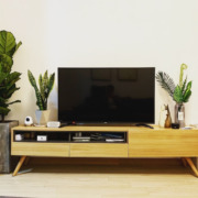 a TV screen placed on a wooden desk