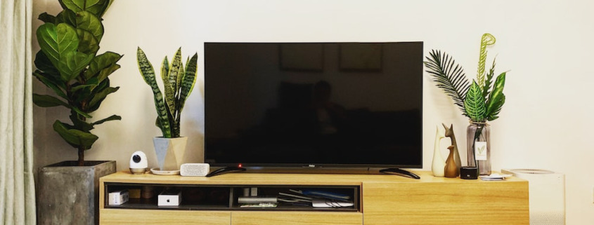 a TV screen placed on a wooden desk