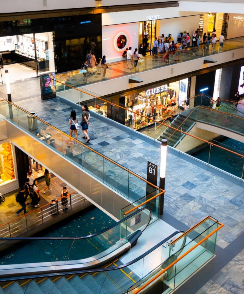 A large shopping mall interior with many people walking around